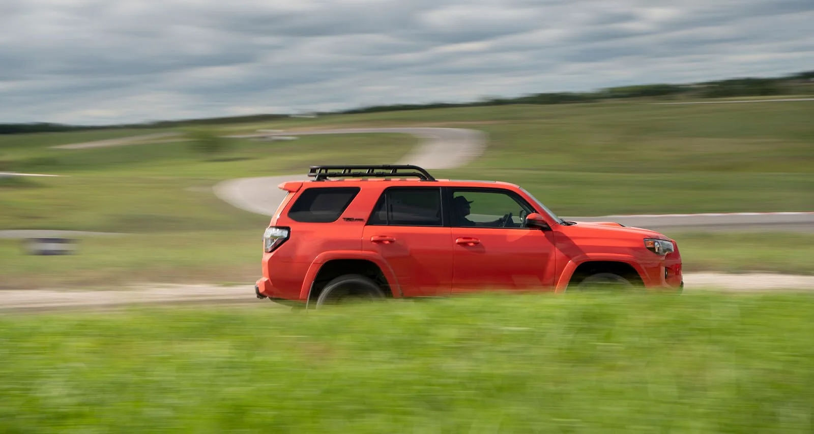 Orange Toyota 4 Runner SUV Side Profile Panning Shot