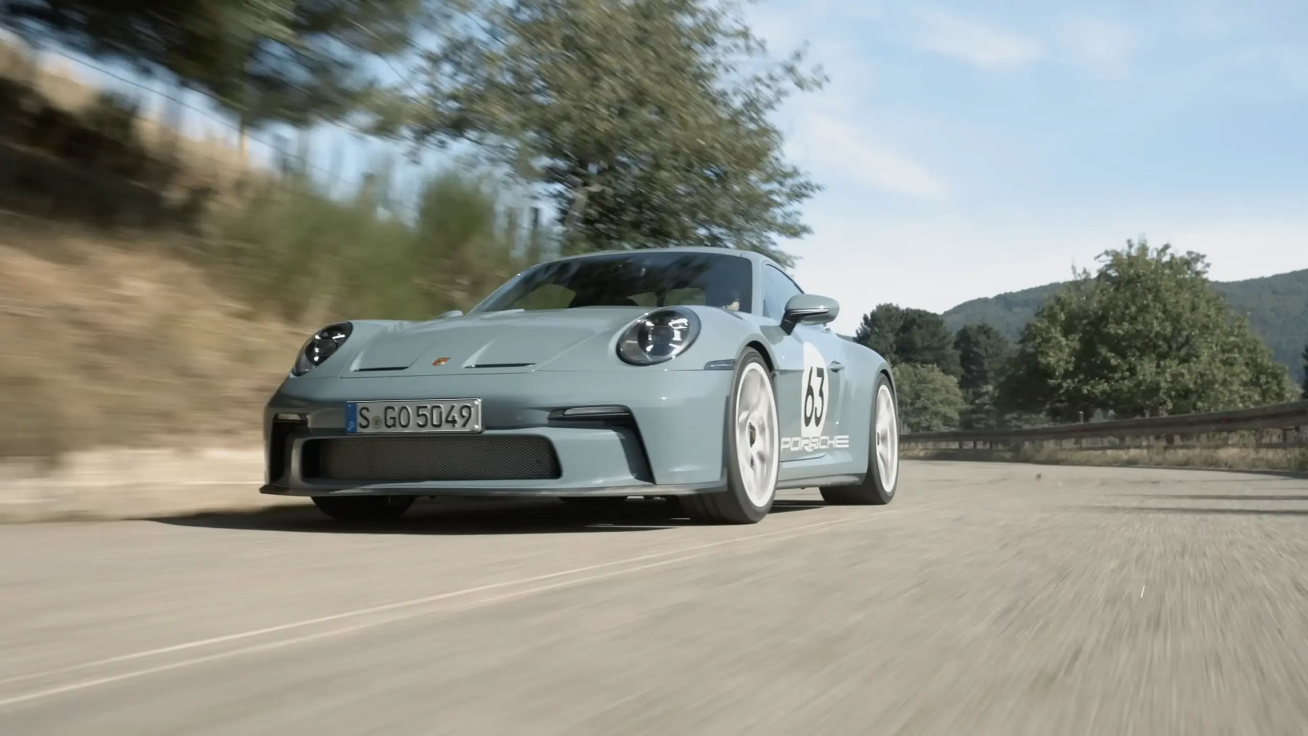 2024 Porsche 911 S/T driving down a road