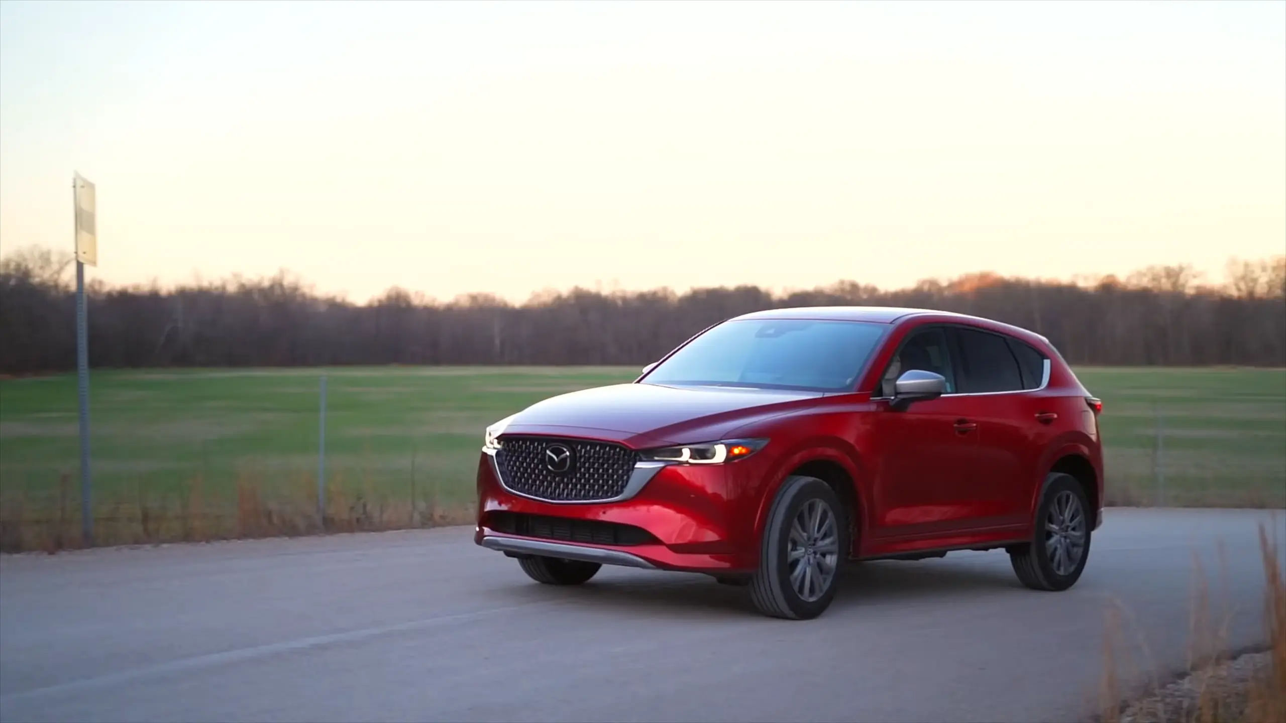 2024 Mazda CX-5 driving down a road