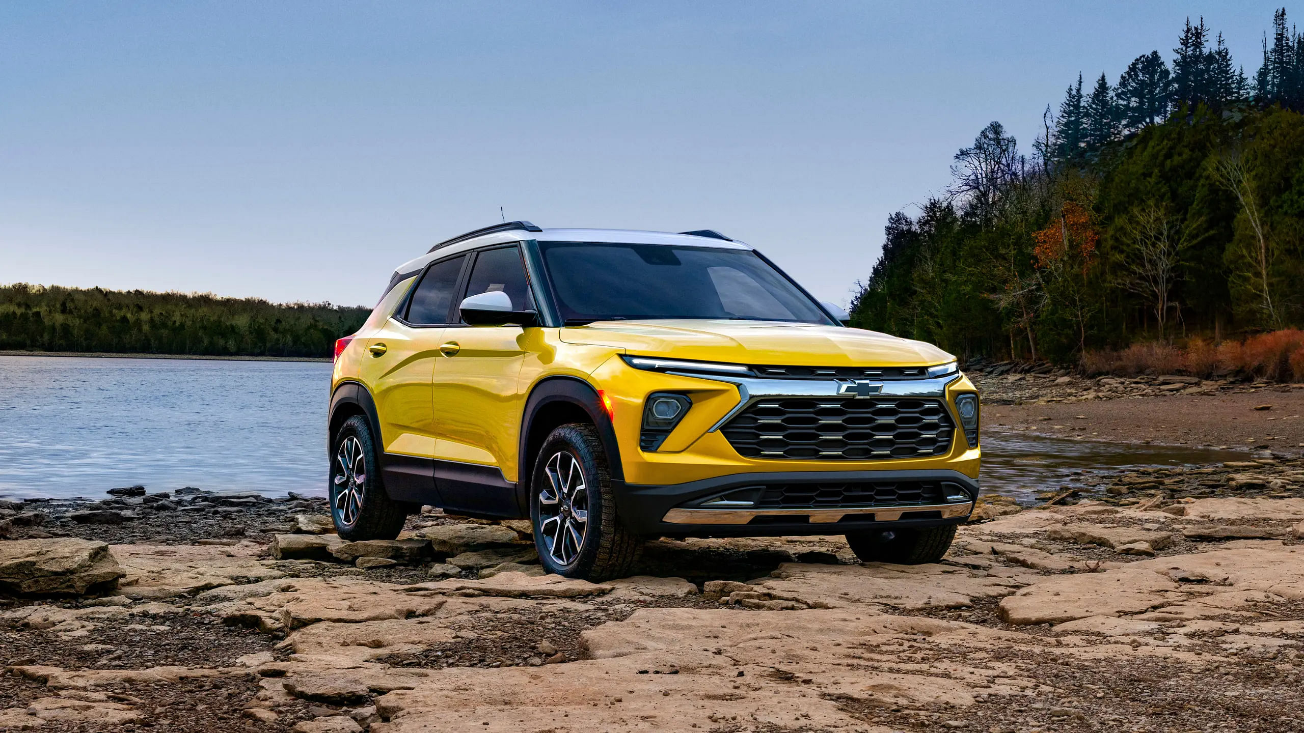 Yellow 2024 Chevrolet Trailblazer Activ stationary in front of a lake