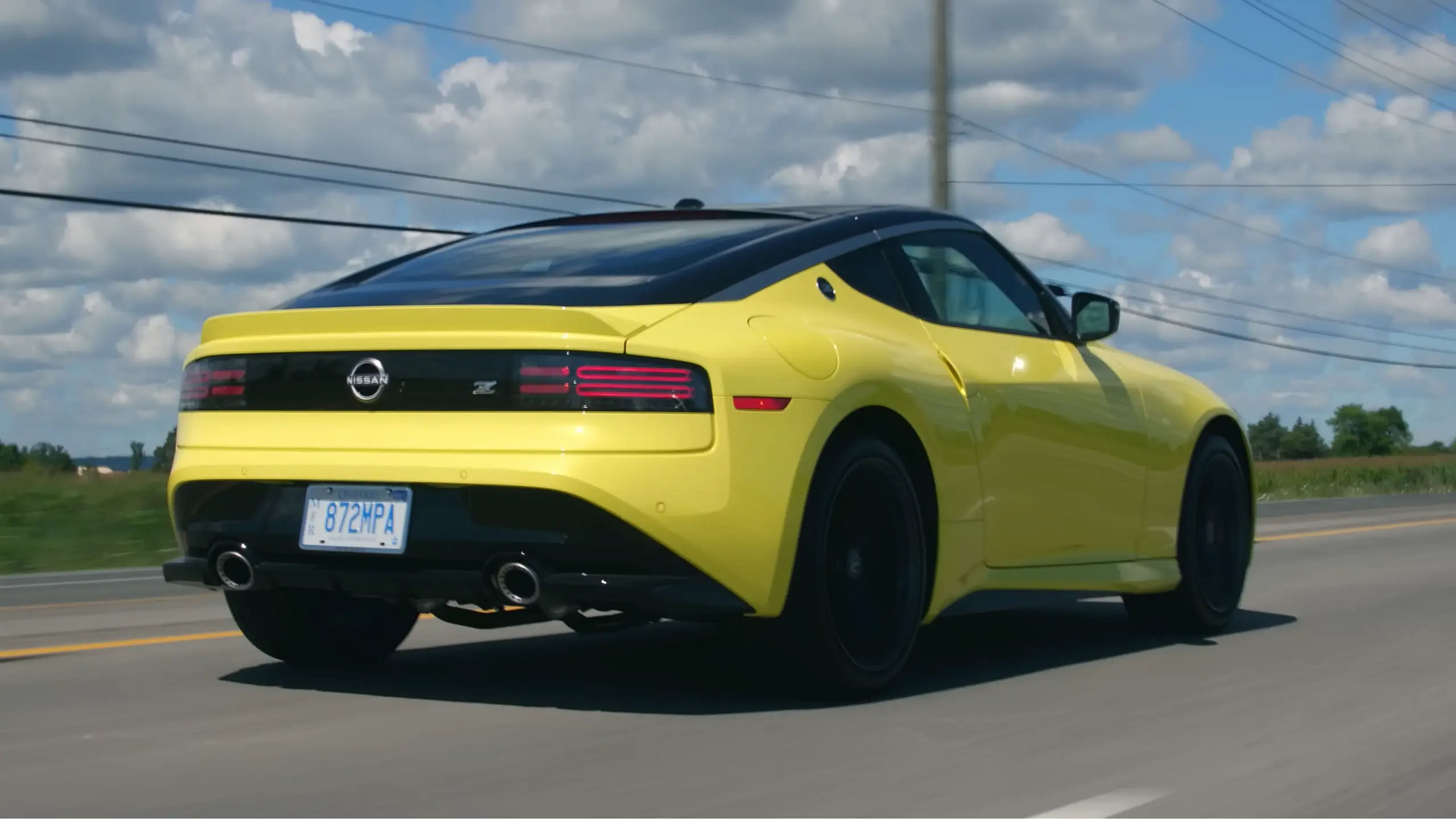 rear view of 2024 Nissan Z driving on the road